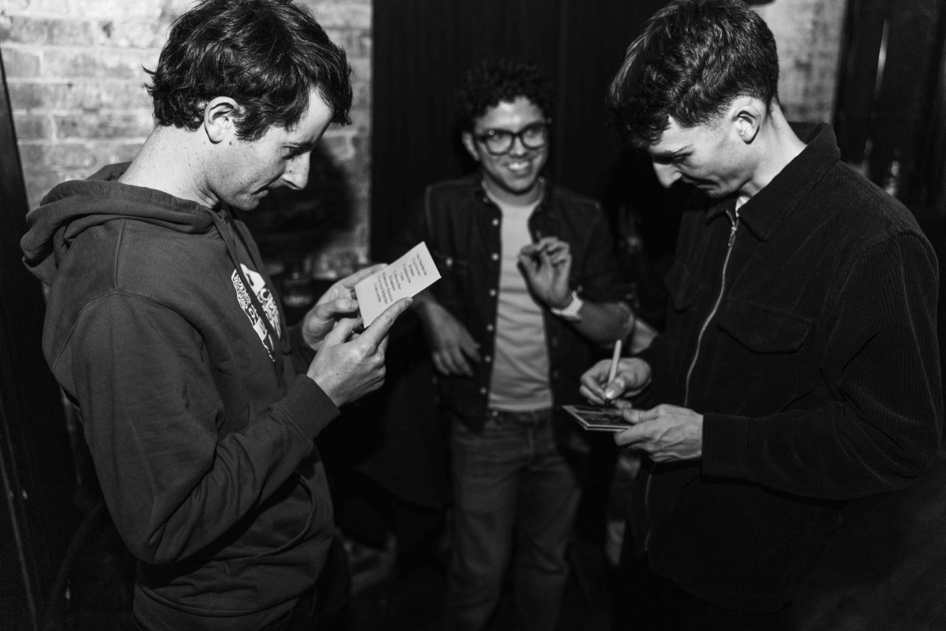 Ben Hulbert signing a card for a listener after a show